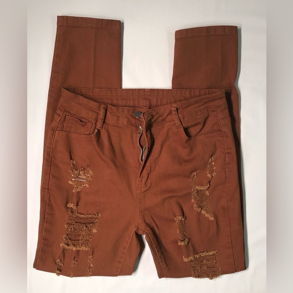 Rust colored ripped woman’s jeans NWOT